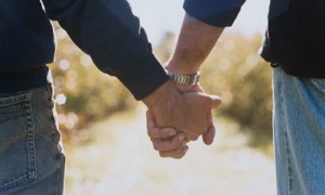 Two men holding hands