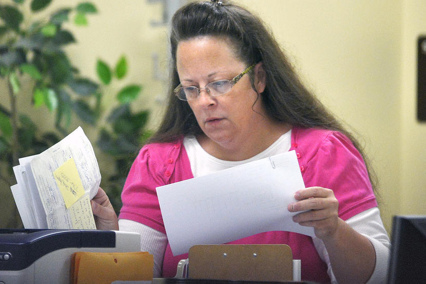 Rowan County Clerk Kim Davis performs her job at the Rowan County Courthouse in Morehead, Ky., Tuesday, Aug. 18, 2015. Davis is back at work and still not issuing marriage licenses while her case is under appeal. U.S. District Judge David Bunning denied Rowan County Clerk Kim Davis' request to delay his ruling from last week ordering her to issue marriage licenses to gay and lesbian couples. That ruling followed the U.S. Supreme Court's decision in June legalizing same-sex marriage nationwide. But Bunning then delayed his own decision, effectively granting Davis' request while also denying it. (AP Photo/Timothy D. Easley)