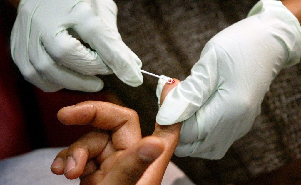 Roberta McShane conducts an HIV/AIDS test, May 8, 2008, in the back room at the New Era Barber and Beauty in Arlington, Texas. (Amy Peterson/Fort Worth Star-Telegram/MCT)