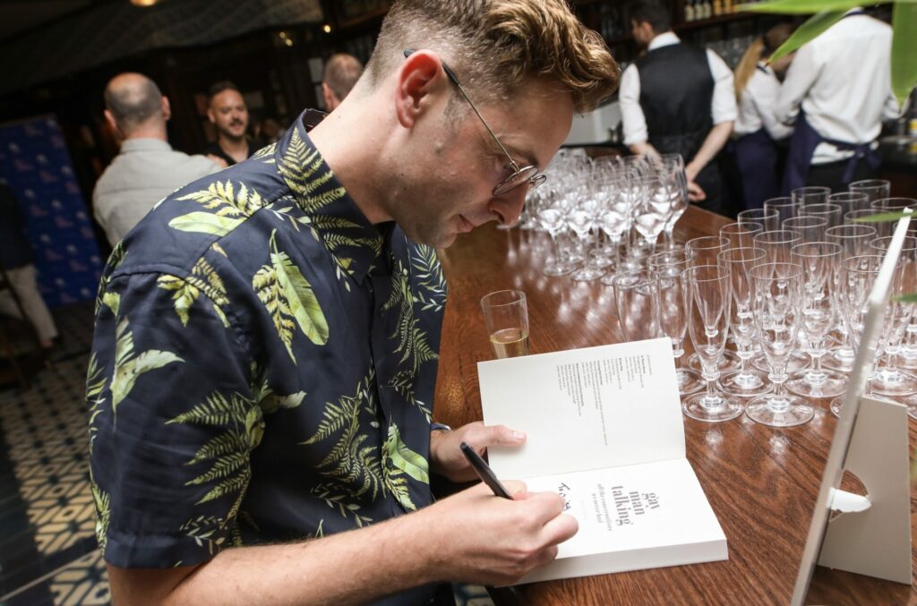 Daniel Harding signs a copy of Gay Man Talking: All the Conversations We Never Had