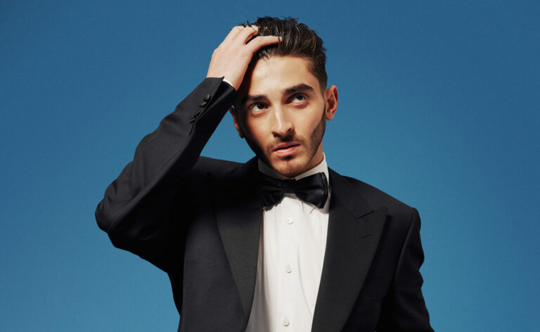 Josh Cavallo wears a tuxedo and black trie for the Attitude Awards issue