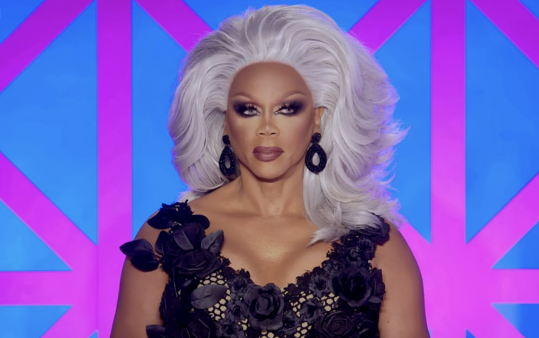 RuPaul in a black dress and silver wig