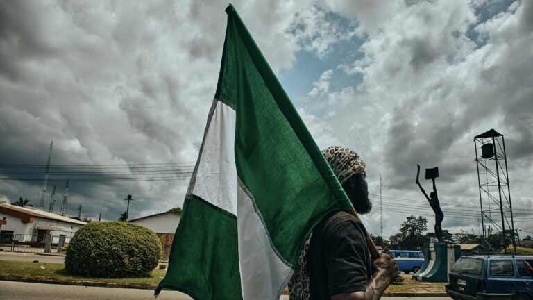 Man carrying the flag of Nigeria