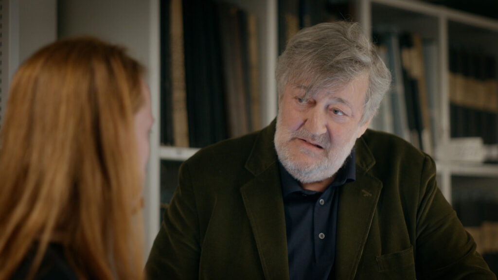 Stephen Fry looking at the Star of David in the De Bazel building it is the Amsterdam City Archive.