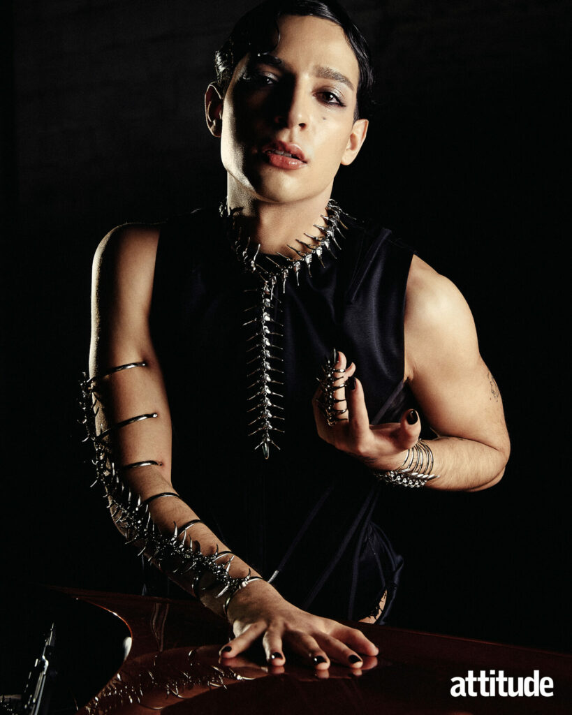 Adam wears corset and skirt by Joseph Pearson; arm brace, necklace, bracelet and ring by Costume Therapy.
