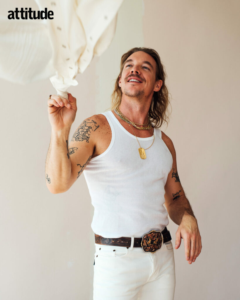 Diplo wears tank top by Sunspel and jeans by RRL
