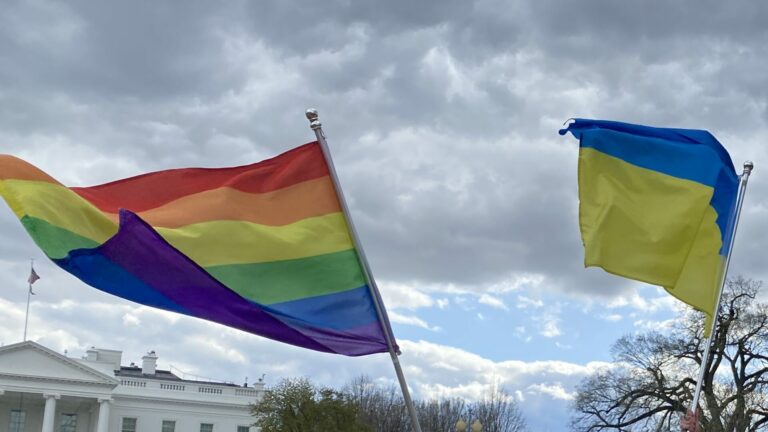 Pride flag and Ukraine flag flying in the wind