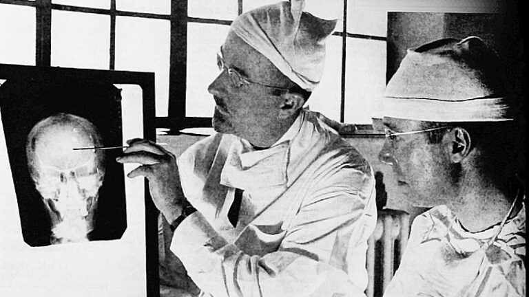 Dr. Walter Freeman, left, and Dr. James W. Watts study an X ray before a psychosurgical operation. (Image: WikiCommons)