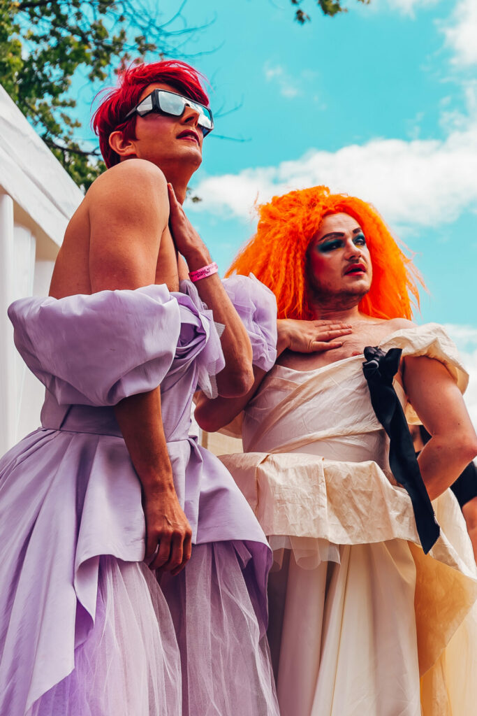 Two festival attendees wearing colourful gowns