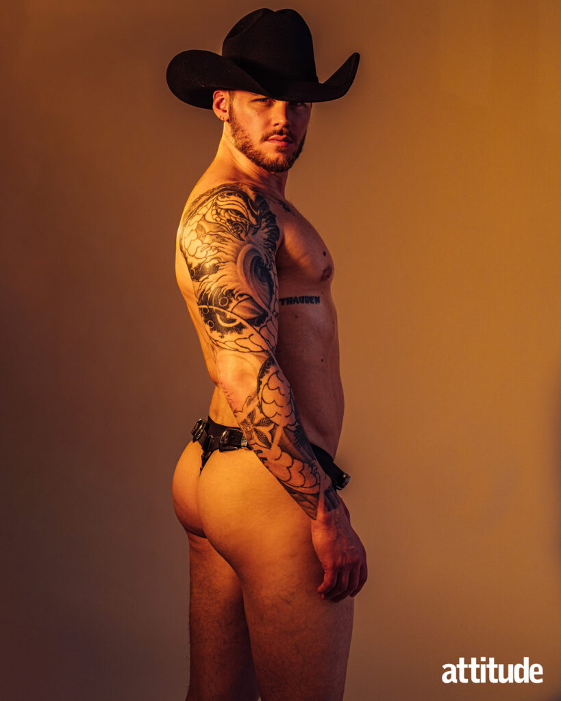 Matthew wears a cowboy hat, stylist's own and underwear by Charlie by Matthew Zink