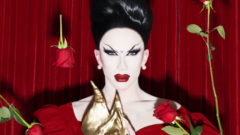 Sasha Velour posing with roses