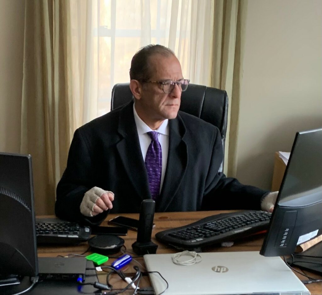 Michael Hakeem of Charles River sitting at a desk