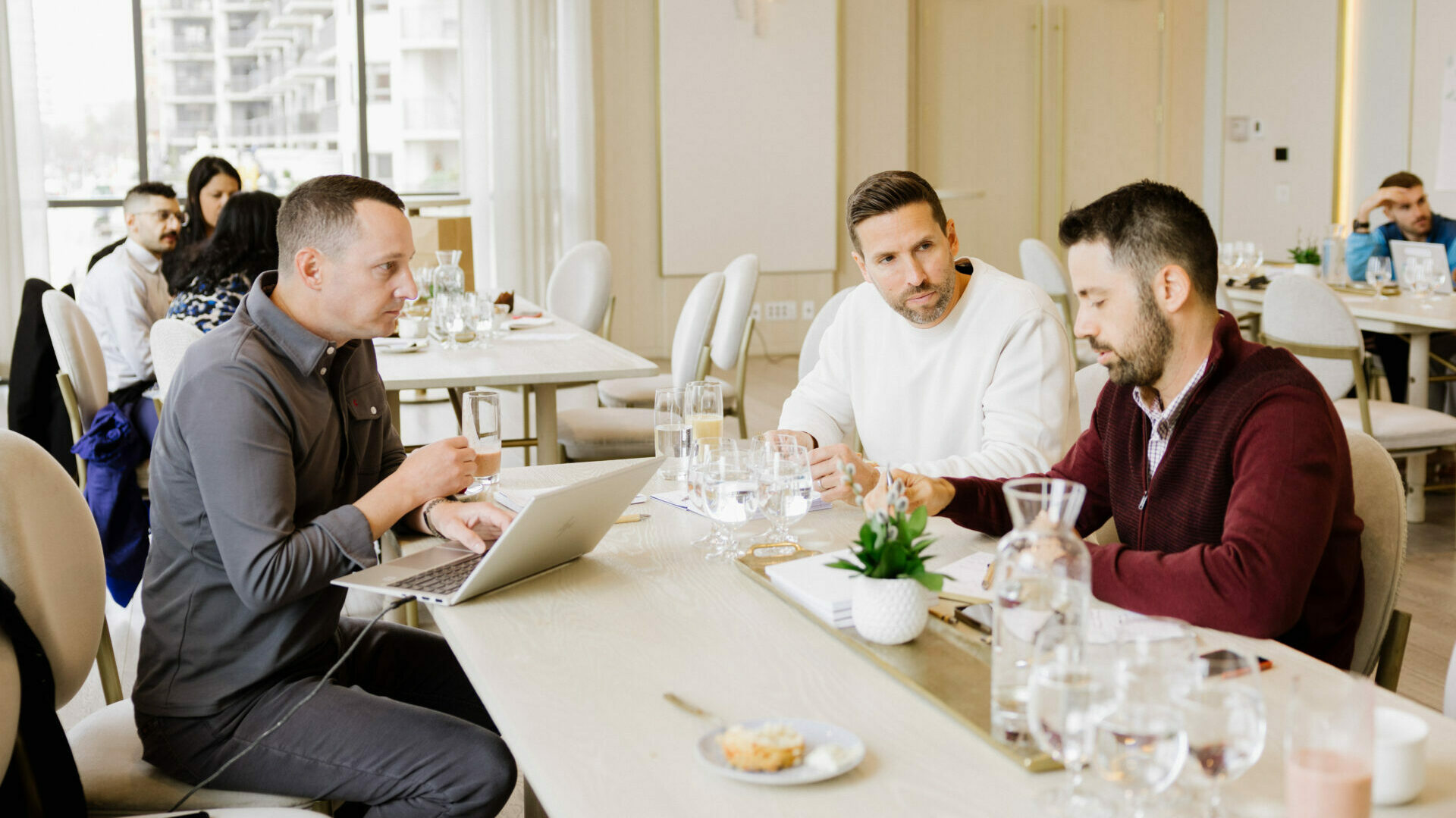 Three people sitting at a table holding a discussion