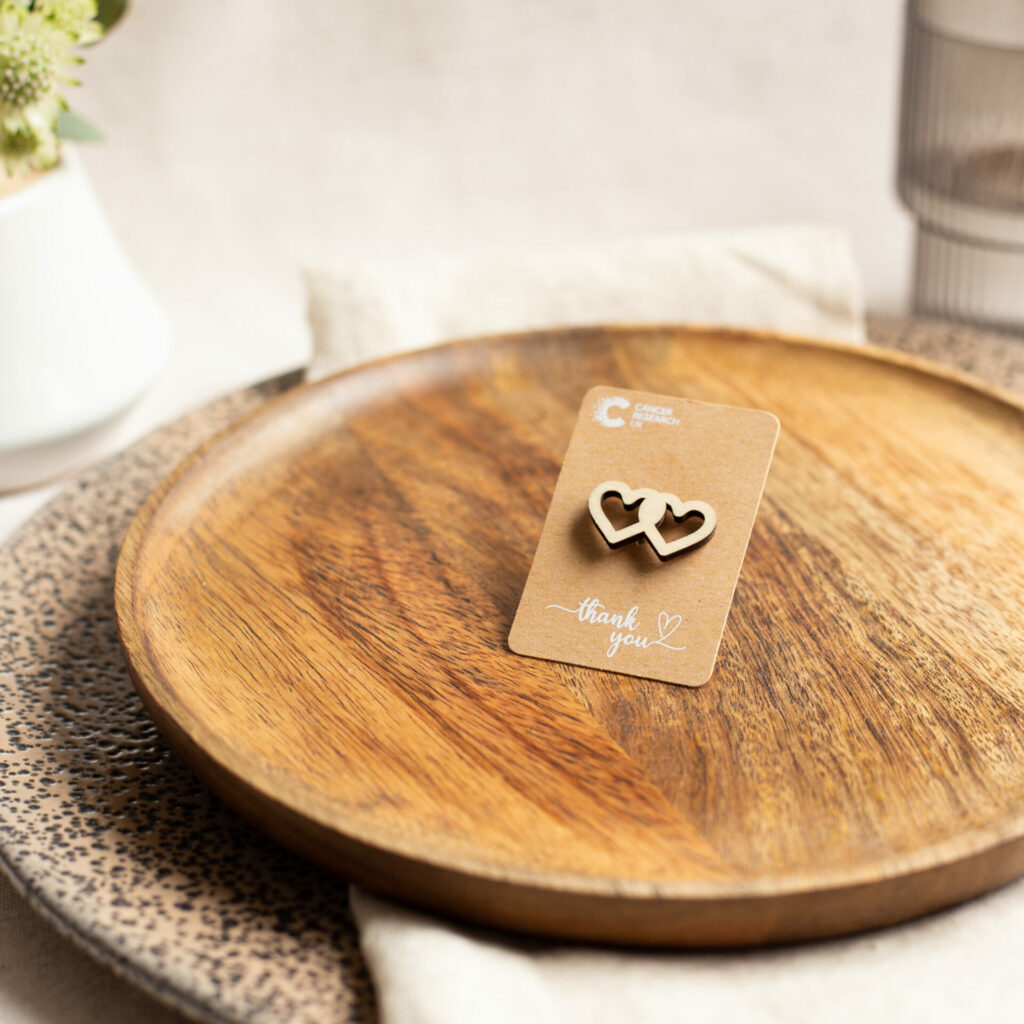 A wooden plate with wedding favour hearts on it