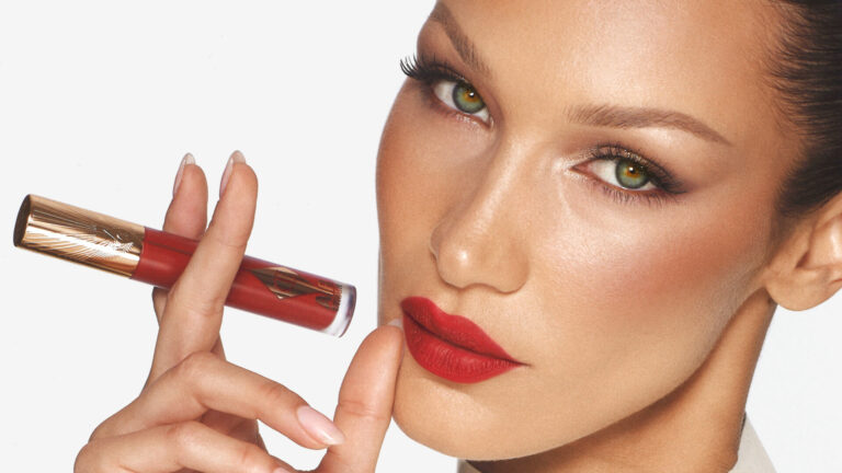 Model Bella Hadid holds a lipstick up to her mouth
