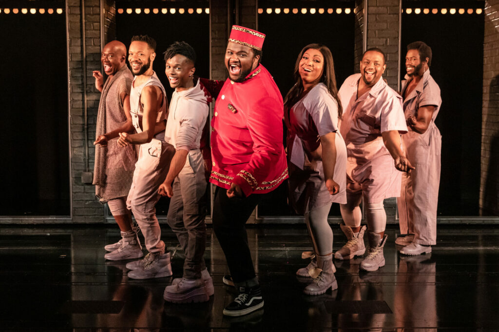 A Strange Loop US production: 7 Black actors on stage in a traingle formation.
