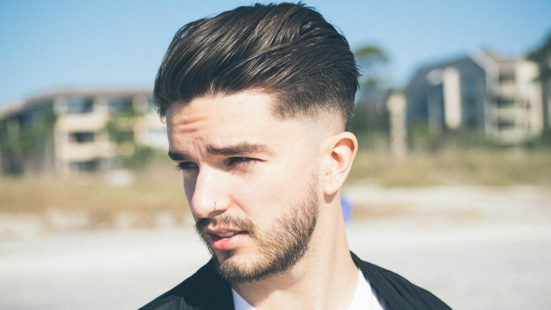Side portrait view of a man with short facial hair