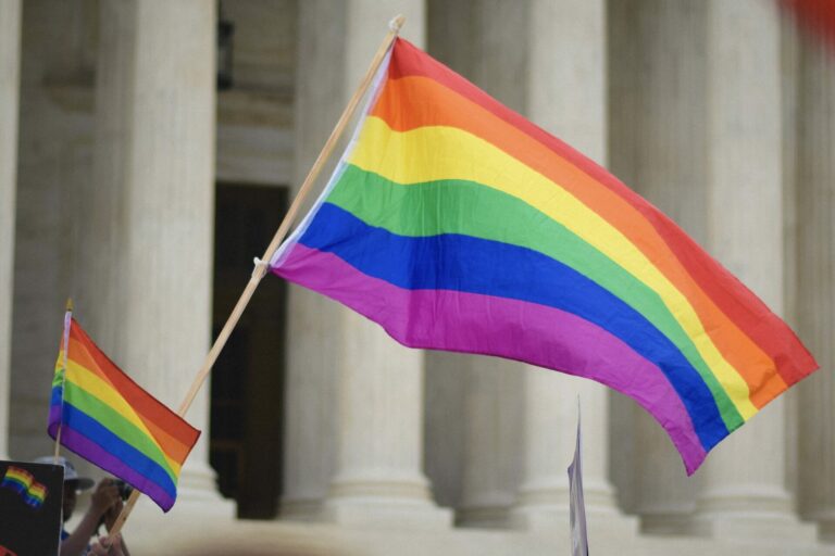 LGBTQ+ Pride rainbow flag blowing in the wind.
