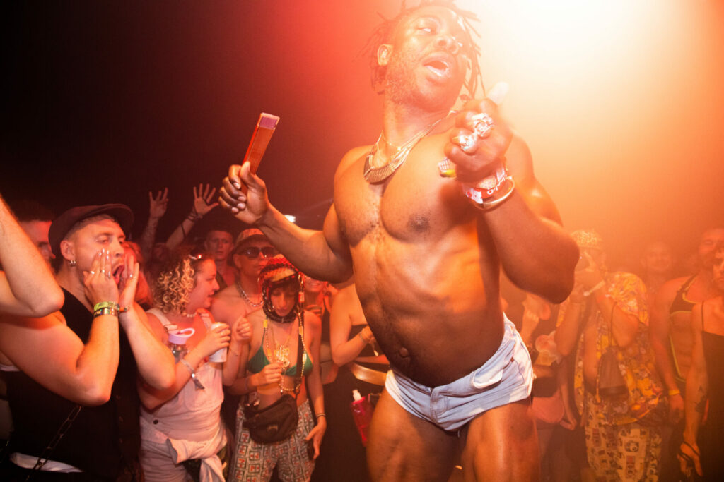 A man on stage wearing small white shorts