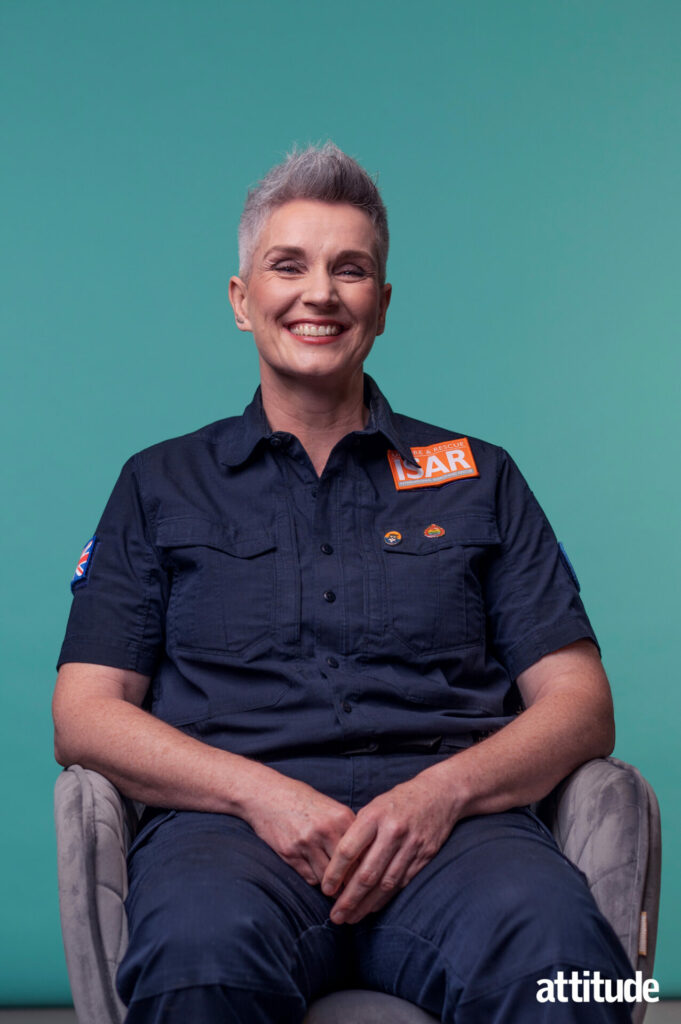 Tracey Doyle sat against a teal background in her Fire Brigade uniform.