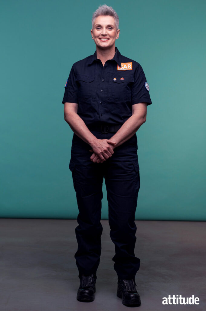 Tracey Doyle standing against a teal background in her Fire Brigade uniform.