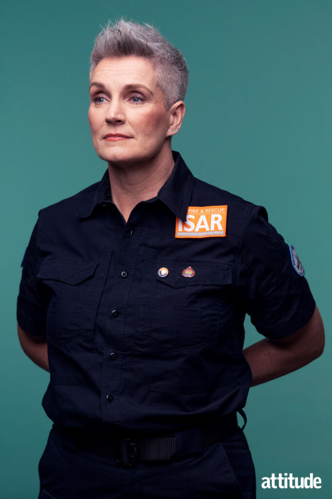 Tracey Doyle standing against a teal background in her Fire Brigade uniform.