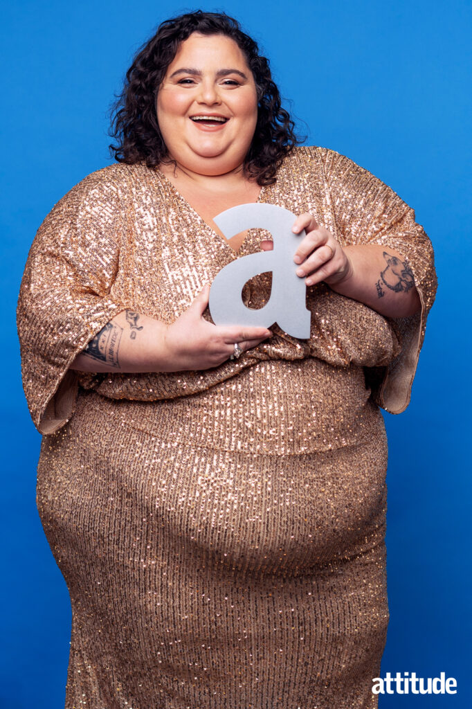 Barbara Butch wearing a glittery golden dressing holding her Attitude 'a' trophy.