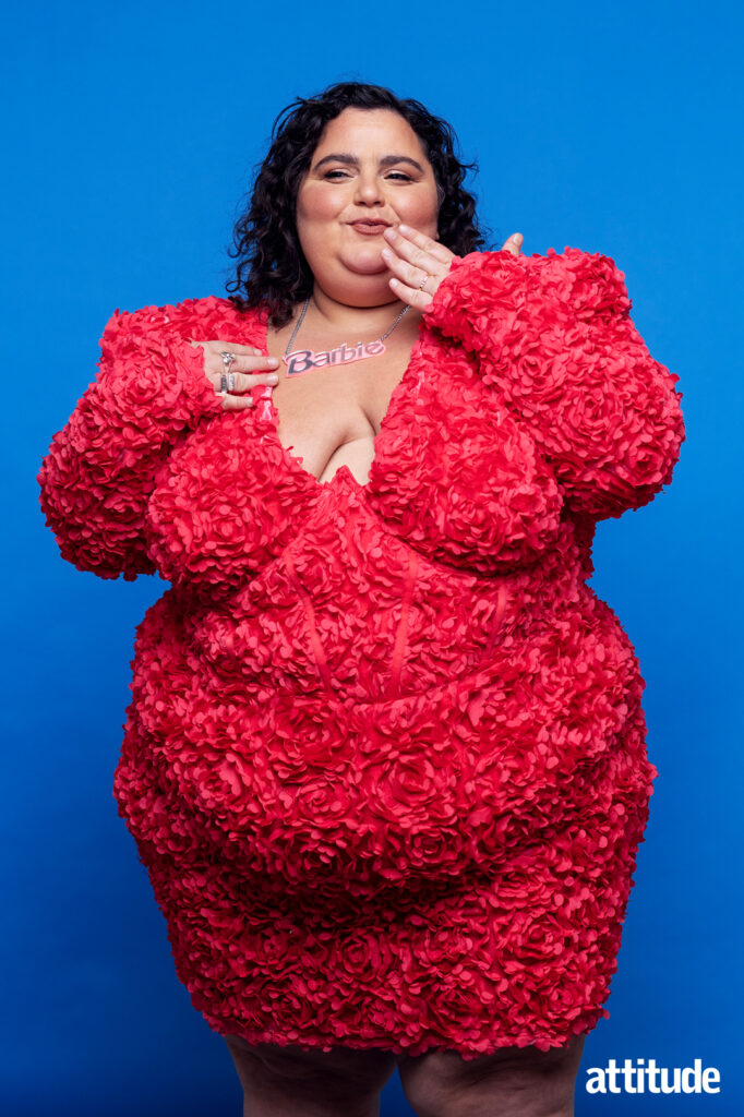 Barbara Butch in a rose-textured dark pink dress with a Barbie necklace.