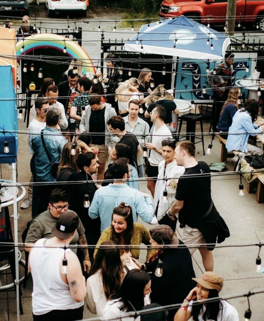 People drinking and talking on an outdoor terrace area