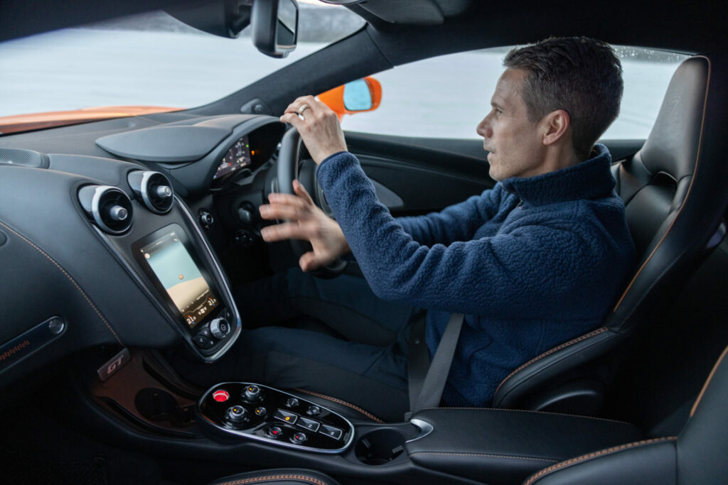 A driver spinning the wheel as the drive on the snow.