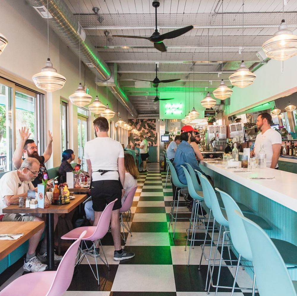 Inside of an American-style diner with people sitting down