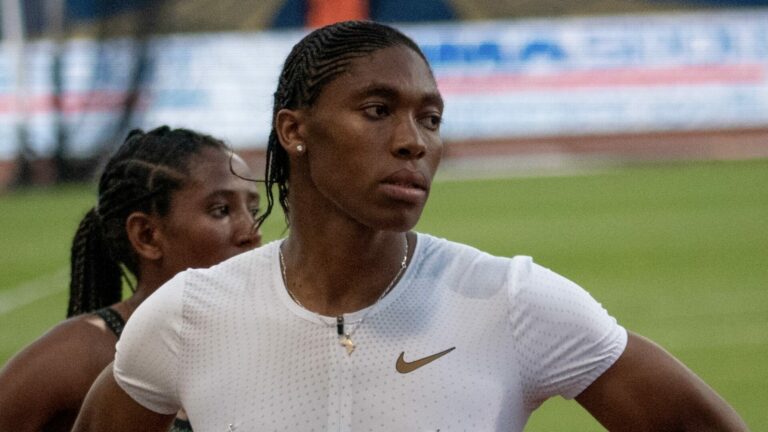 Caster Semenya wearing a white Nike sports top as she stands on the race track.