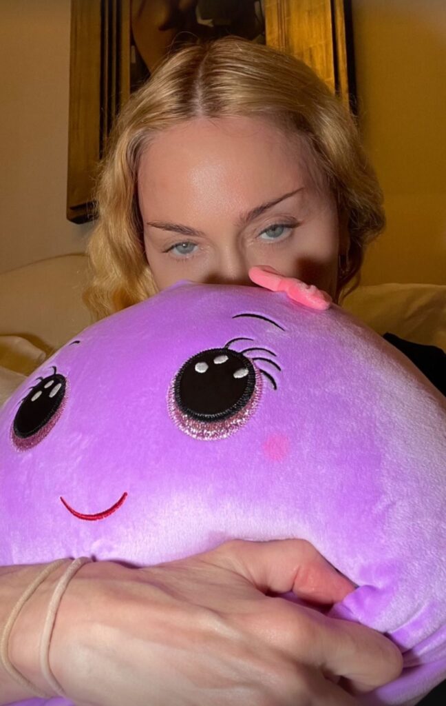 Madonna holds a purple plush toy