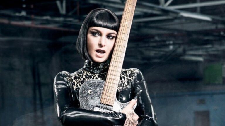 Sinead O'Connor in a black wig holding a guitar (Image: Nettwerk)