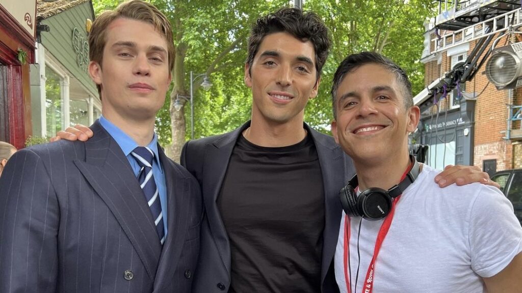 Nicholas Galitzine and Taylor Zakhar Perez posing with director Matthew López on set of "Red, White, & Royal Blue" movie.