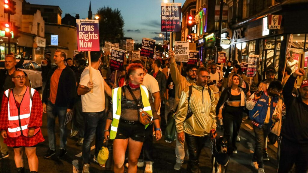 A group of people protest on the streets of Clapham holding banners
