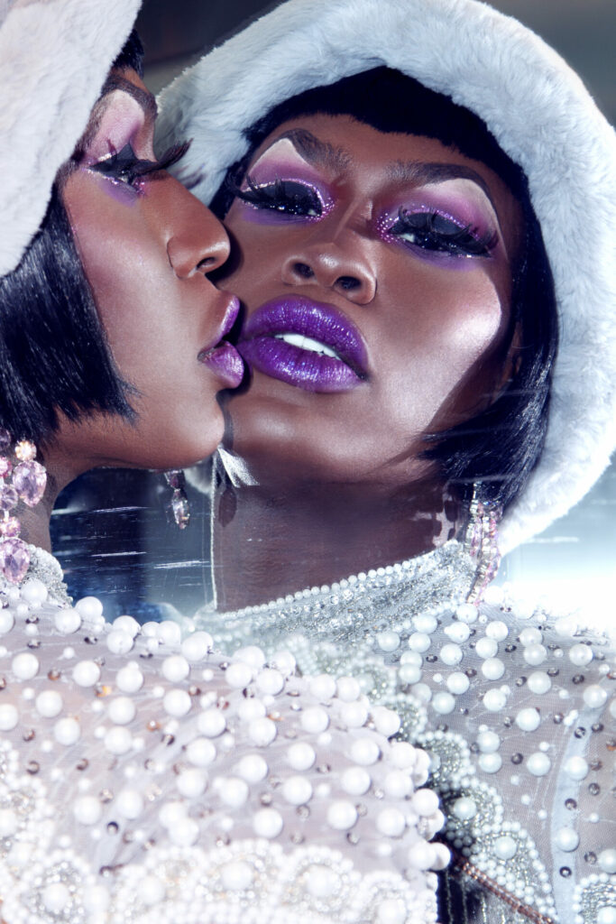Close up of Shea Coulee looking in a mirror