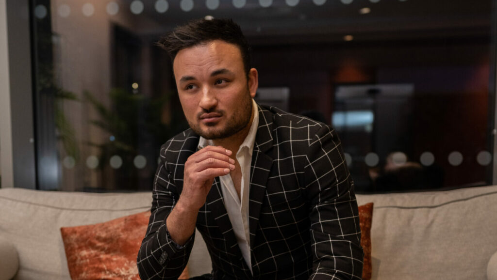 The writer Lewis Oakley sitting down in a suit