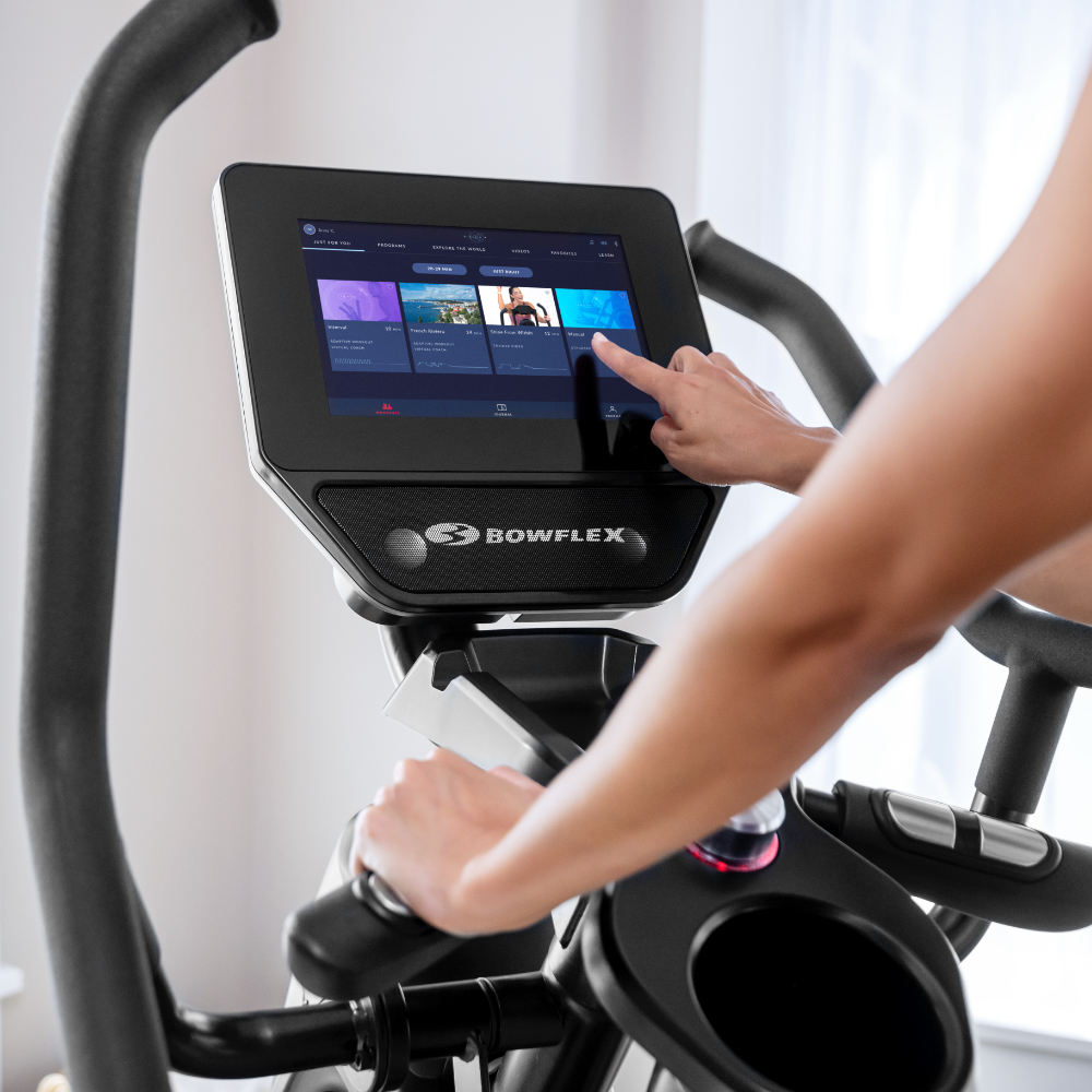 Close up of a person touching the display of a training machine