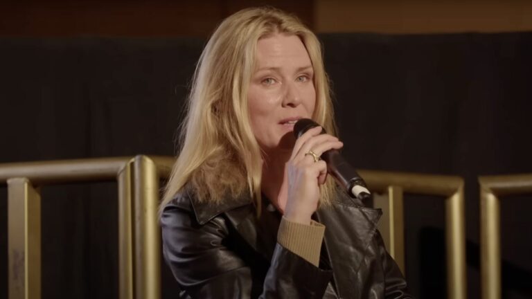 Róisín Murphy wearing a black jacket speaking into a microphone