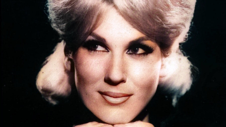 Close up of Dusty Springfield's face looking off the right woth black background
