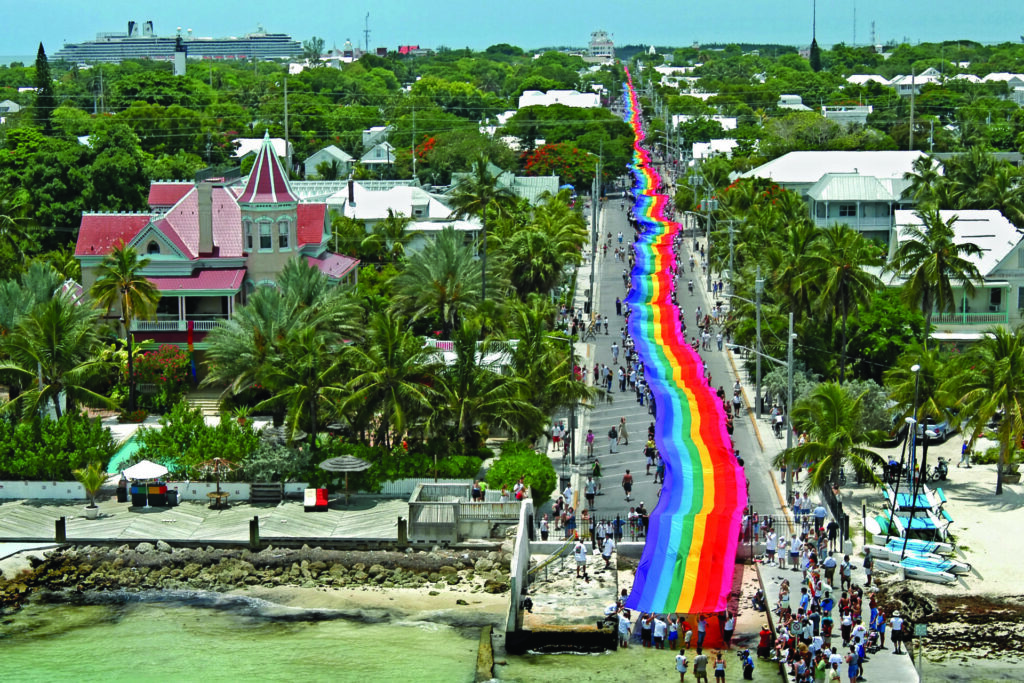 Aerial view of a street in Florida with a huge Pride flag stretching down it