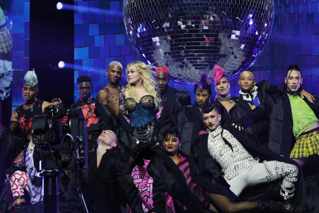 Madonna onstage at the Celebration Tour surrounded by dancers