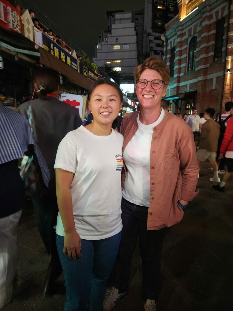 Two women hug and smile into the camera