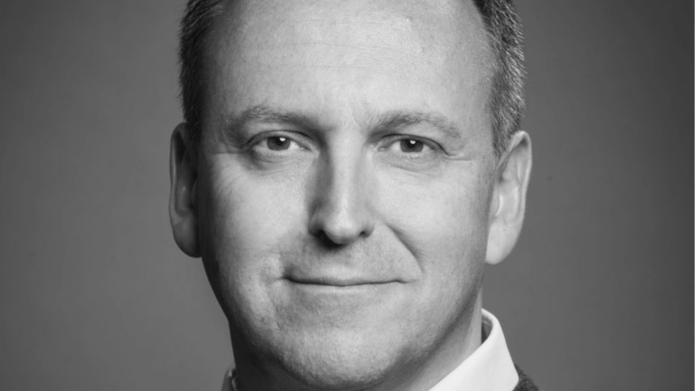 Black and white portrait shot of a smiling man