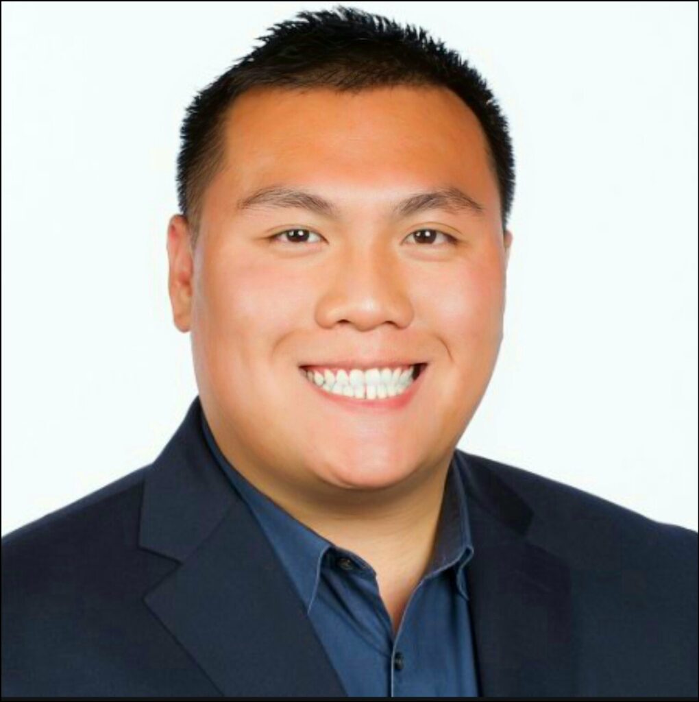 Profile shot of a smiling man against a white background