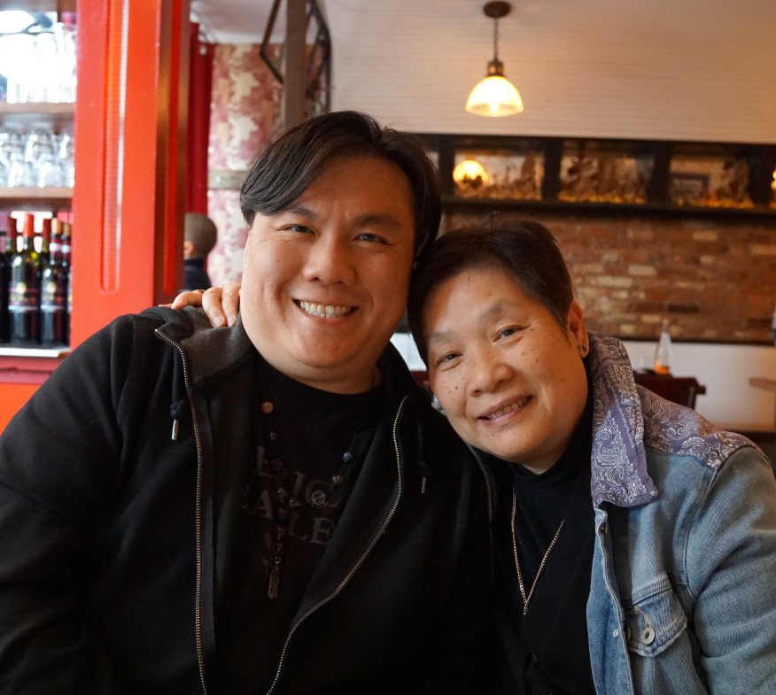 Mother and son hug inside a restaurant