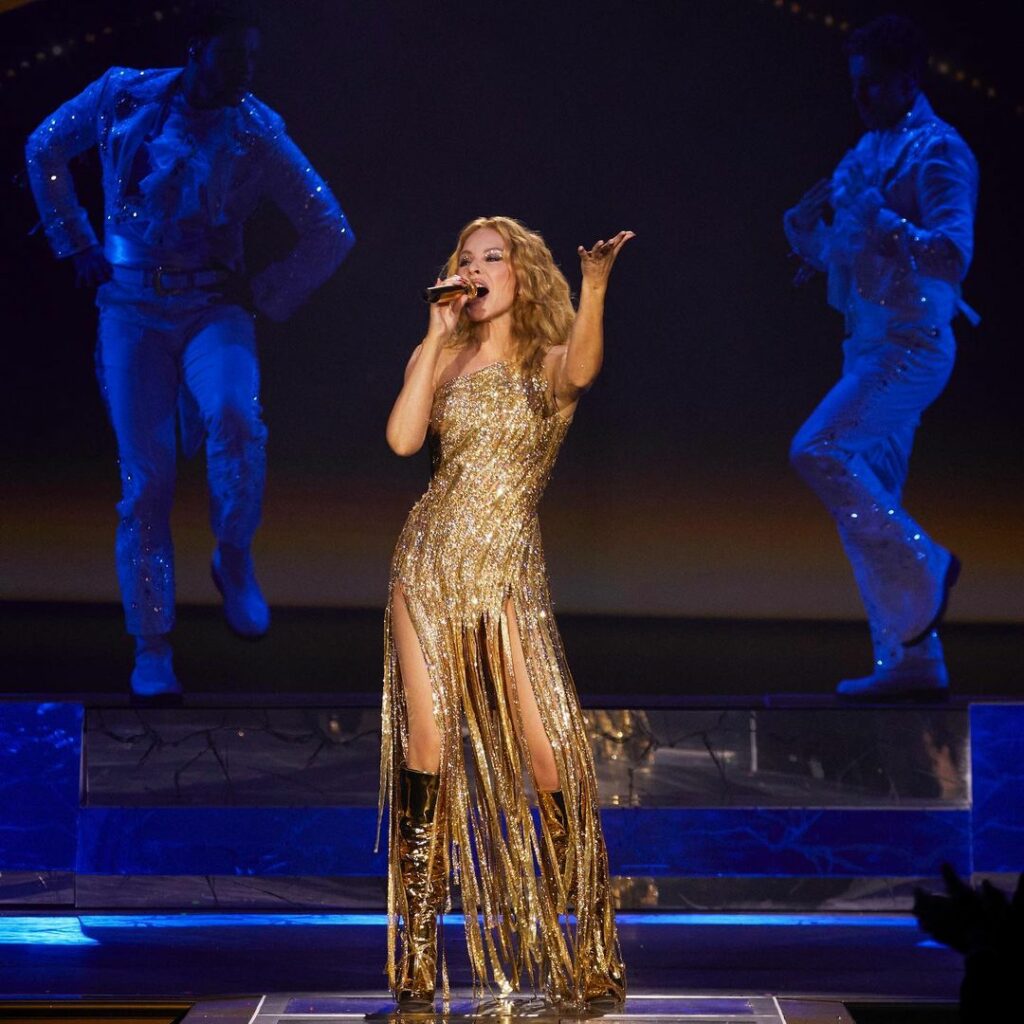 Kylie performs during her Las Vegas residency wearing a gold dress