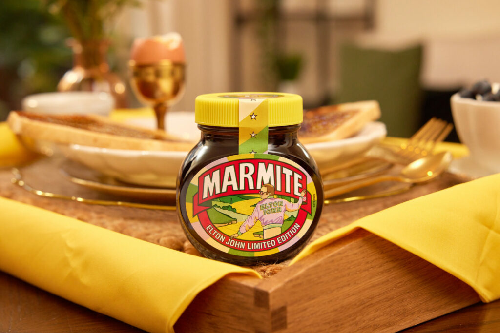 Close up of a Marmite jar featuring artwork of Elton John