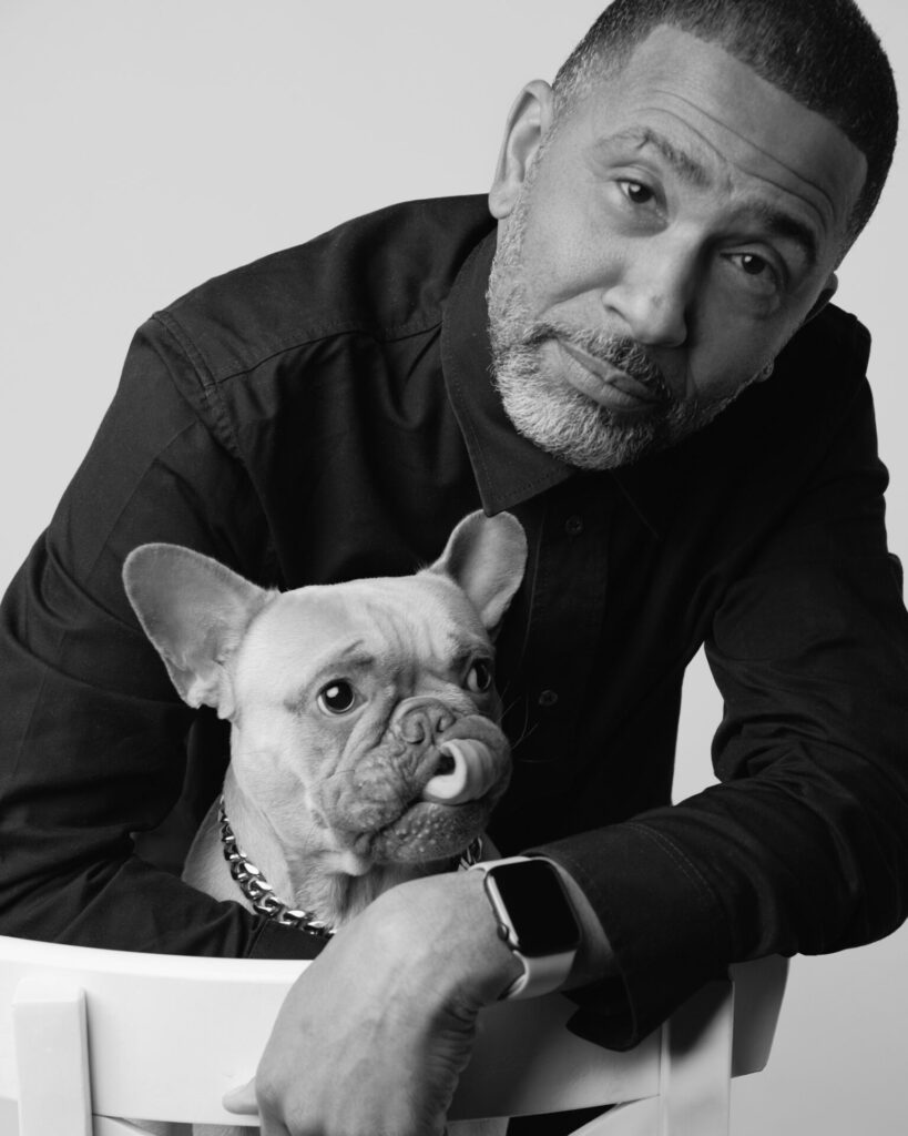 Black and white portrait shot of a man holding a dog